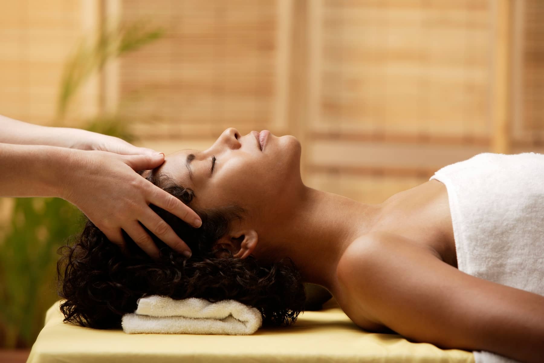 Massage therapist working on a client's back during a deep tissue massage treatment.